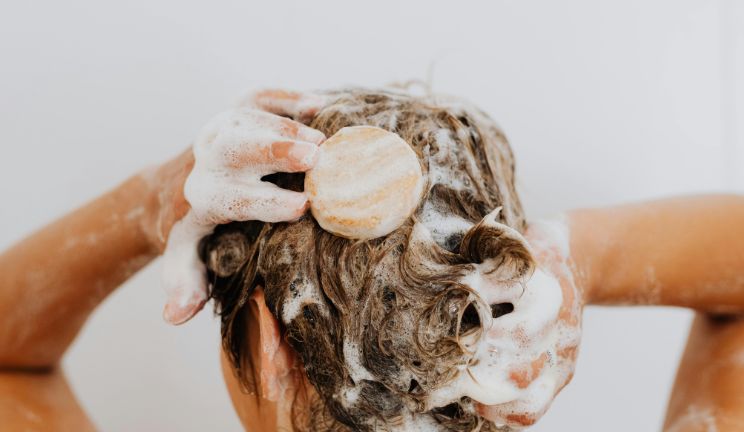 woman washing her hair with solid low poo