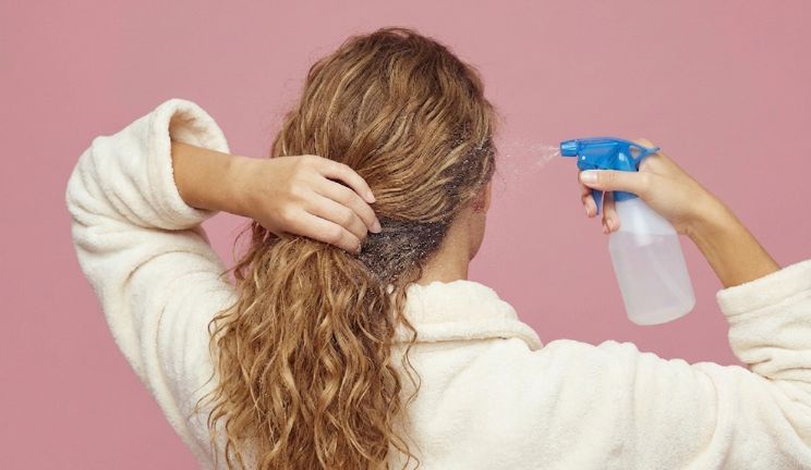 woman refreshing her wavy hair